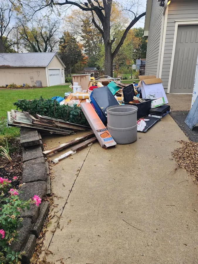 Dumpster being loaded with debris for Estate Cleanout Dumpster Rental in Laketown